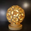 Sandstone Garden Light Ball with carved floral hexagon pattern