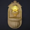 Sandstone Wall Fountain with carved arch niche and warm glow