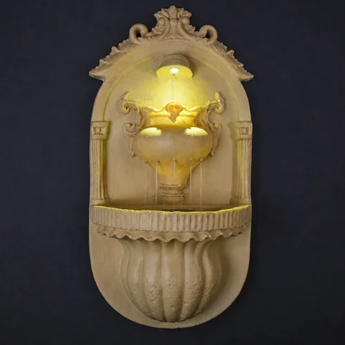 Sandstone Wall Fountain with carved arch niche and warm glow