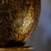 Golden Orb Pedestal Lamp with glowing sphere on antique base