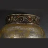 Antique Carved Wall Light with glowing amber shade and silver-brown finish