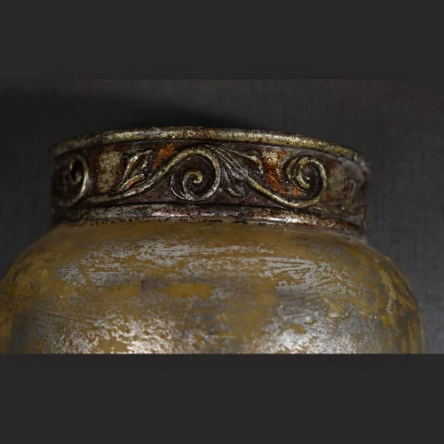 Antique Carved Wall Light with glowing amber shade and silver-brown finish