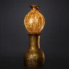 Golden Orb Pedestal Lamp with glowing sphere on antique base
