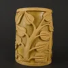Sandstone garden light with vine-carved design glowing on a patio