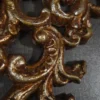 Antique Carved Wall Light with glowing amber shade and silver-brown finish
