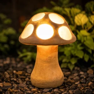 Glowing sandstone mushroom garden light with round carved cut-outs at night