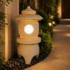 Curved roof and rounded finial of the sandstone garden lantern