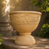 Decorative sandstone planter and pot with rounded bowl shape and floral detailing