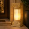 Add a graceful silhouette to your outdoor space with our sandstone garden light, a flared vase design finished with an elegant vine-carved body. Built to withstand the elements while adding timeless charm, this piece suits gardens, patios, walkways, and entryways beautifully. Flared Top Design Skilled artisans shape the crown of this sandstone garden light into a wide, gentle flare, inspired by classic vase silhouettes. The open, flowing top contrasts beautifully with the detailed carving below, giving the piece a graceful, balanced profile that draws the eye from a distance. Vine-Carved Column Body Flowing vines and delicate floral patterns wrap the cylindrical body of this sandstone garden light. Every leaf and petal is carved by hand, and once switched on, warm light glows softly through the detailed cutwork. The continuous vine pattern wraps around the column, creating a natural, garden-inspired look that reads beautifully by day and glows warmly by night. Glowing Fiber Illumination Inside the stone shell, a durable fiber lining delivers soft, even illumination. The fiber glows warmly through every carved detail, casting a gentle light across the surrounding space after sunset — perfect for creating a relaxed, welcoming outdoor atmosphere. Durable & Weather-Resistant Build Crafted from premium natural sandstone, this garden light is made to handle outdoor conditions year-round: - Washable — simply rinse with water to keep it looking fresh - Weatherproof — resists rain, sun, and seasonal wear - Sturdy construction — a tiered base keeps it stable outdoors - Low maintenance — no repainting or protective coating required With its flared vase top, hand-carved vine detailing, and warm glowing light, this sandstone garden light is a lasting addition to any outdoor setting.