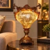 Ornate fiber glass decorative lamp with glowing body and pedestal base