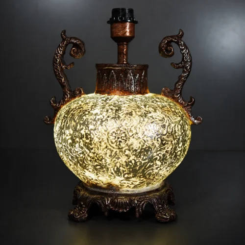 Ornate fiber glass table lamp with curved decorative handles
