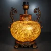 Ornate fiber glass table lamp with curved decorative handles