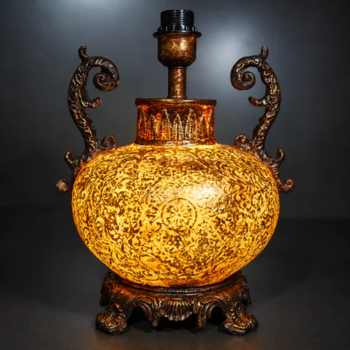 Ornate fiber glass table lamp with curved decorative handles