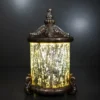 Ornate fiber glass lantern lamp with glowing cylindrical shade