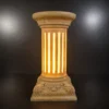 Sandstone fluted column garden light glowing warmly on a dark background