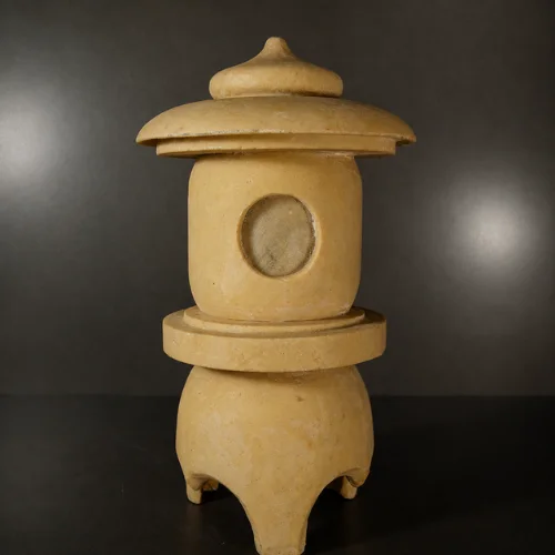 Curved roof and rounded finial of the sandstone garden lantern