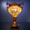 Ornate fiber glass decorative lamp with glowing body and pedestal base