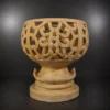 Decorative sandstone planter with intricate carved openwork design and pedestal base