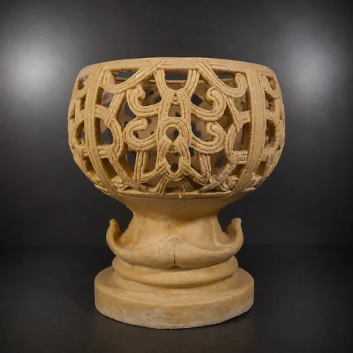 Decorative sandstone planter with intricate carved openwork design and pedestal base