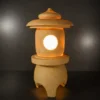 Curved roof and rounded finial of the sandstone garden lantern