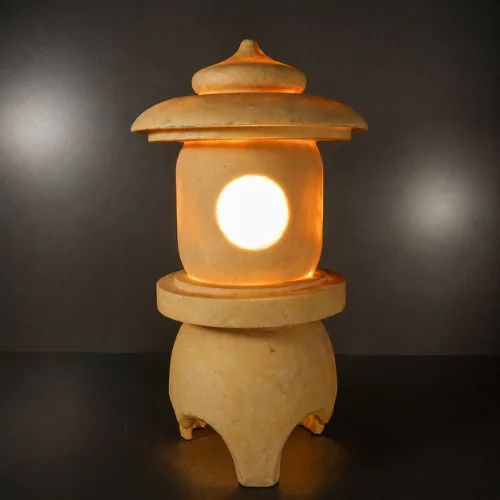 Curved roof and rounded finial of the sandstone garden lantern